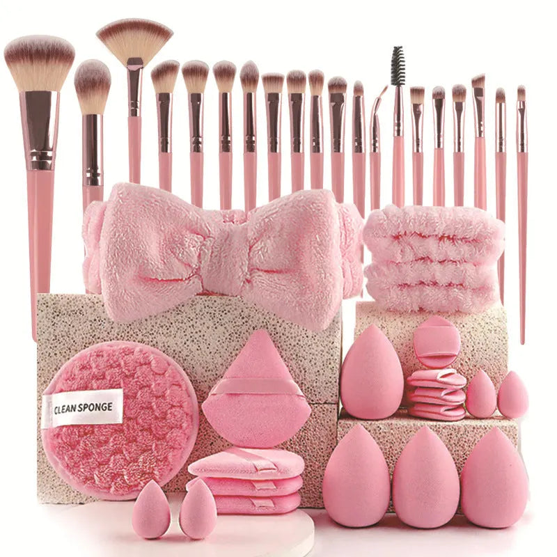 Beauty tool combination set with multiple pieces in pink, brown and purple colours for face wash and makeup application