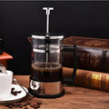 Glass manual pour-over coffee maker with stainless steel filter, 350ml capacity.