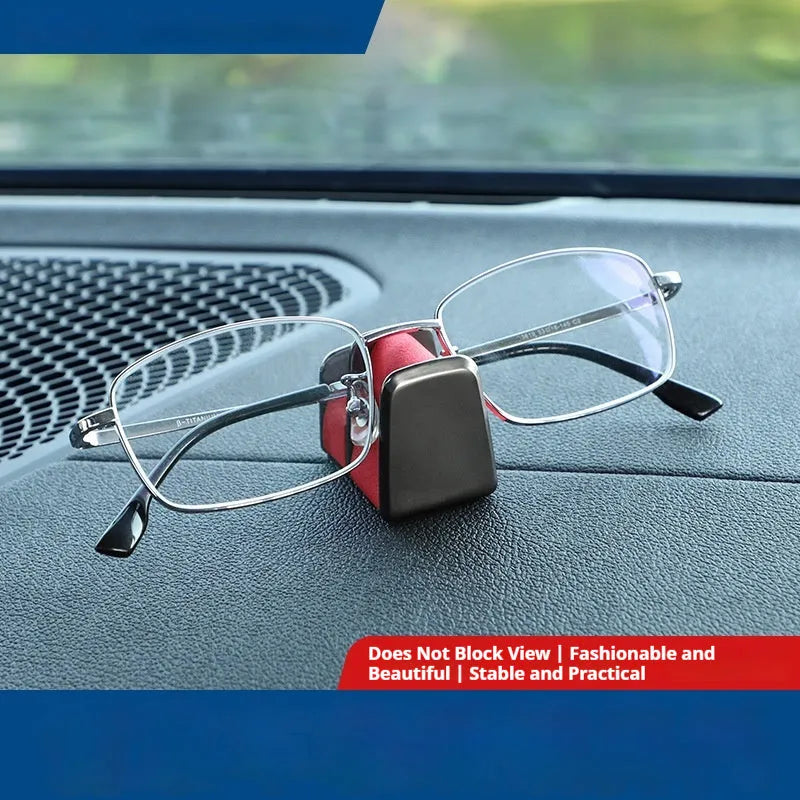 Green zinc alloy and leather glasses clip holder mounted on a car dashboard.