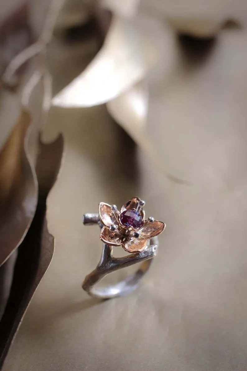 Silver two-tone women's ring with geometric shapes and floral design elements on alloy metal