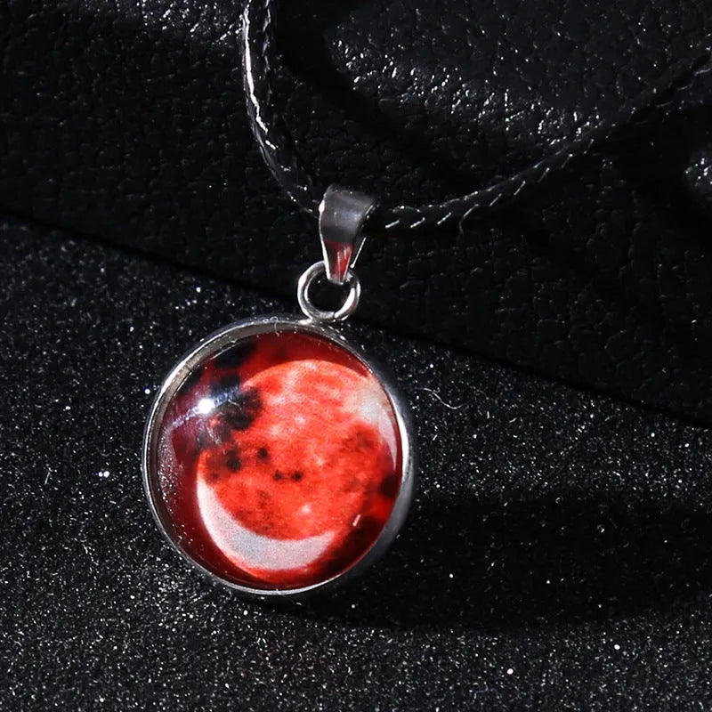 Luminous alloy and organic glass constellation pendant necklace with adjustable chain on white background.