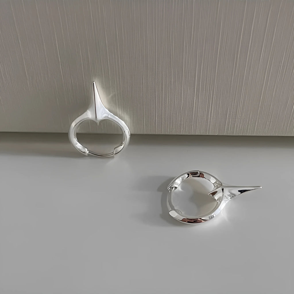 Women's geometric star-shaped ear clip with an electroplated platinum or white gold finish.