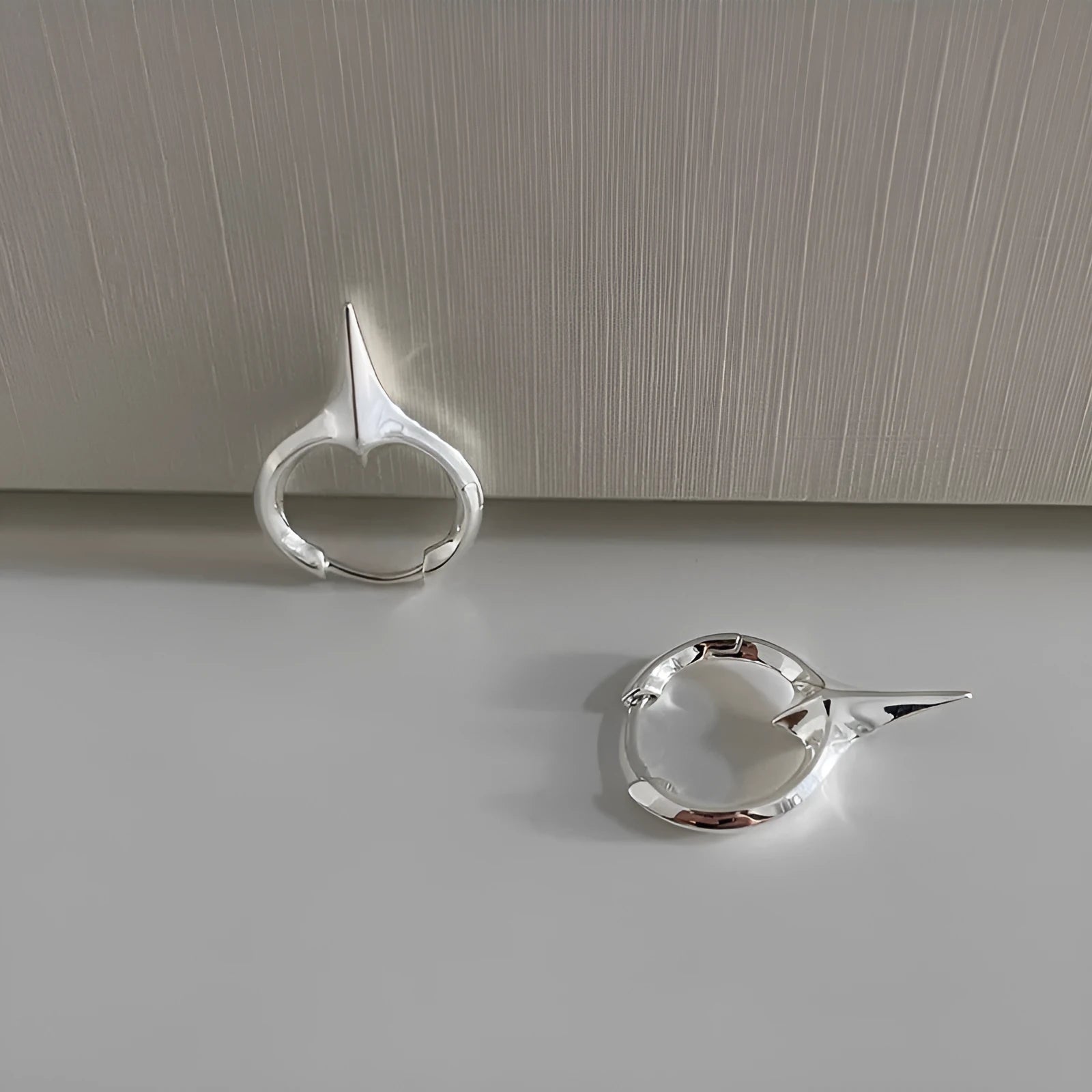 Women's geometric star-shaped ear clip with an electroplated platinum or white gold finish.