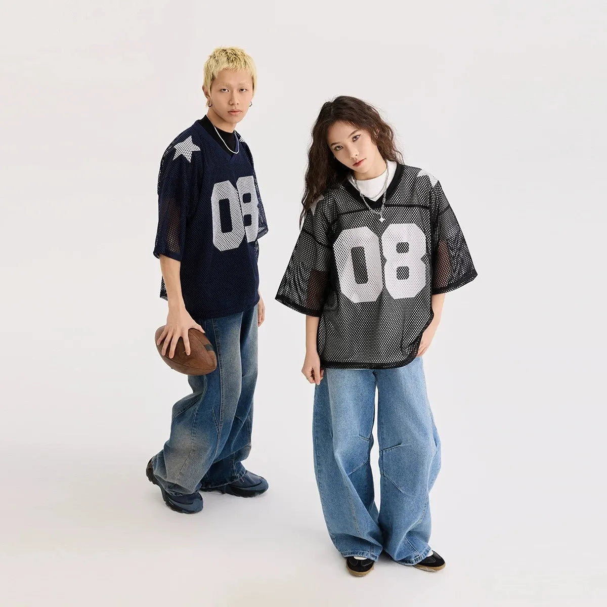 Black loose fit pullover shirt with a white letter pattern across the chest, modelled on a mannequin.
