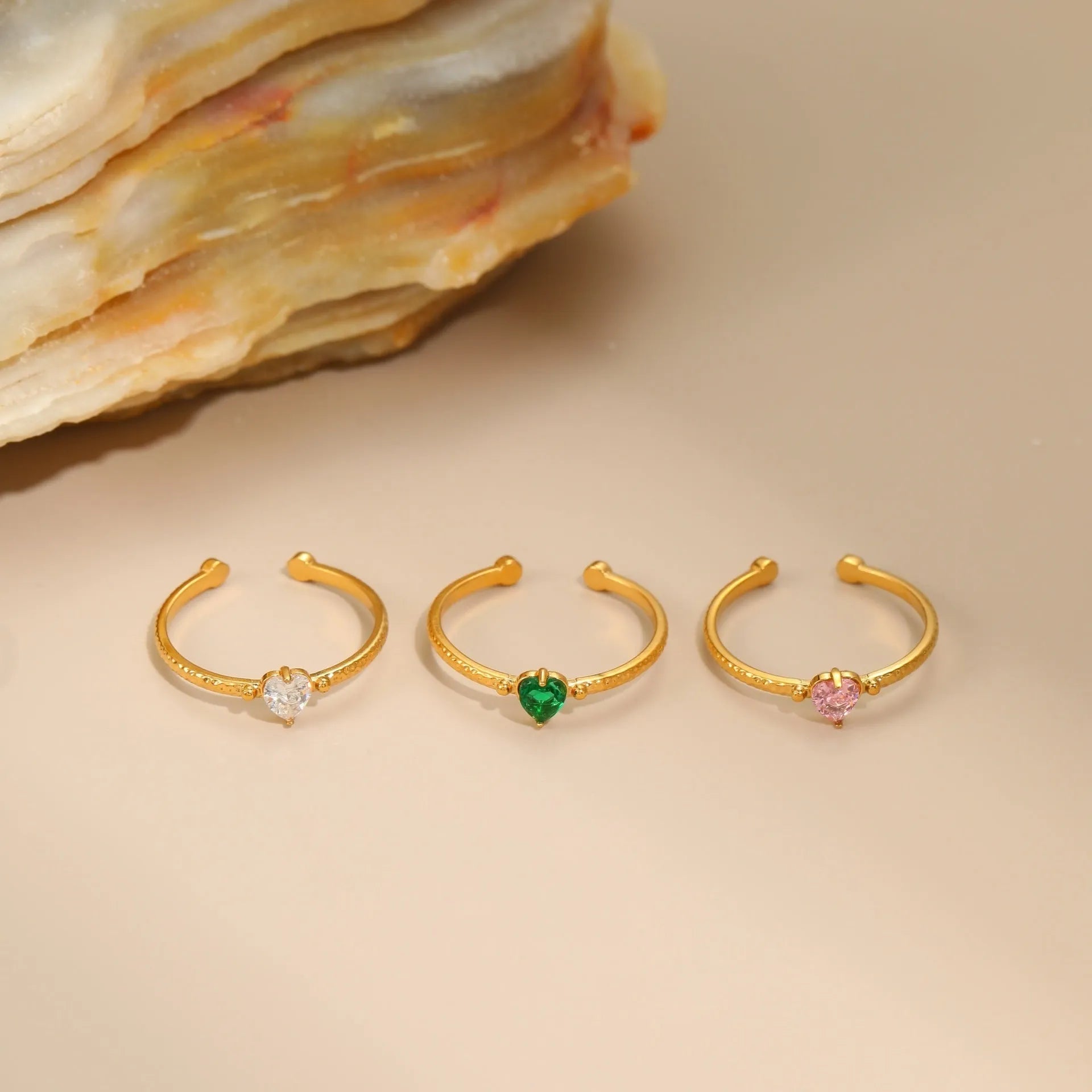 Open ended stainless steel ring with heart-shaped zirconium inlay in white, pink or green