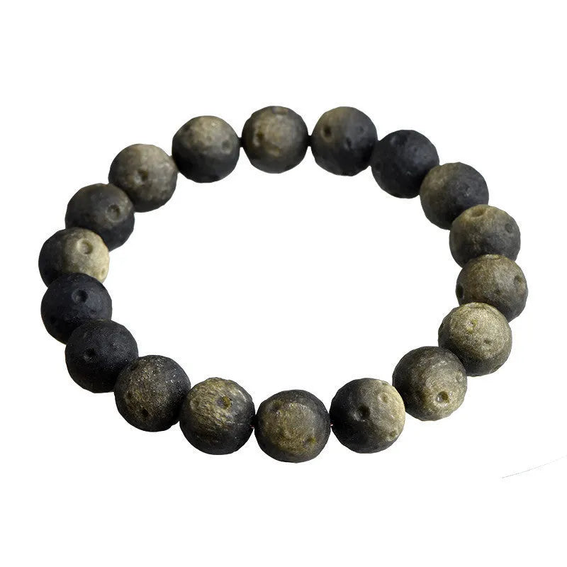 Natural obsidian crater ball bracelet with polished beads in silver or gold meteorite finish.