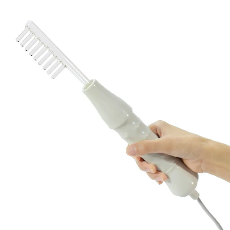 White hand held high frequency electrotherapy comb with glass tube accessories for acne and mite removal in box packaging
