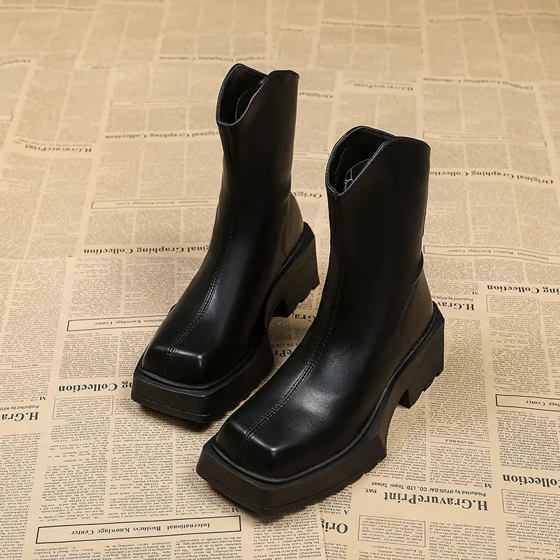 Black platform Martin ankle boots for women with a square toe and back zipper.