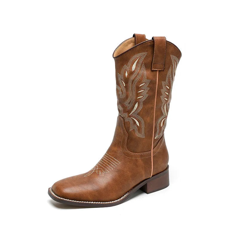 Brown women's mid-calf Martin boots with embroidered detail on the upper and a low square heel.