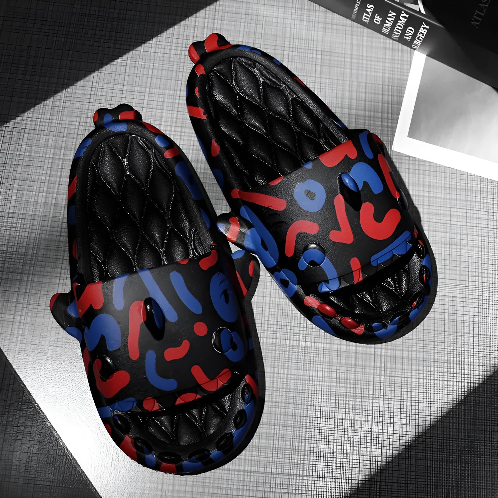 Cute shark design open toe EVA home slippers in assorted colours on a white background.