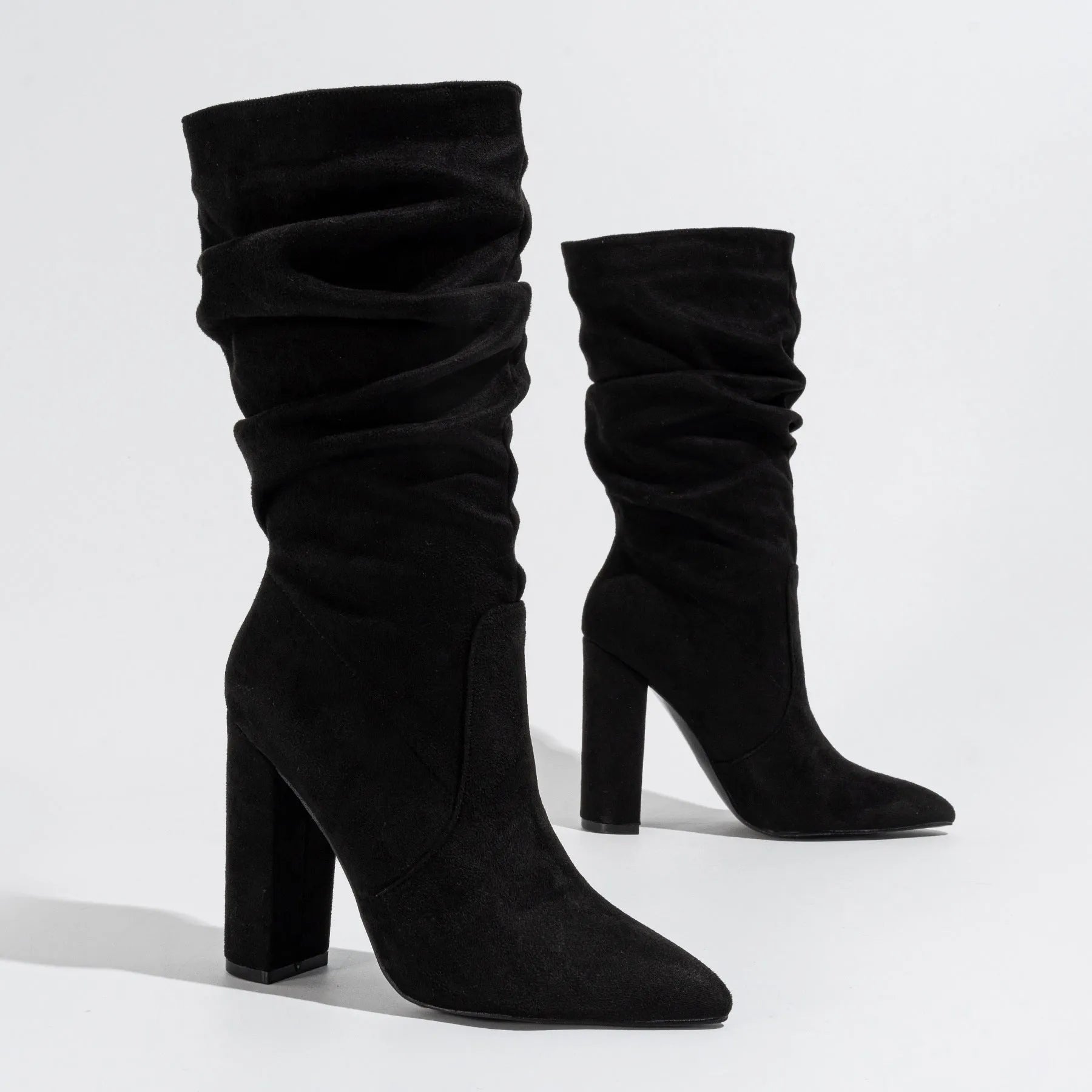 Women's black suede chunky heel pointed-toe mid-calf boots on a white background.