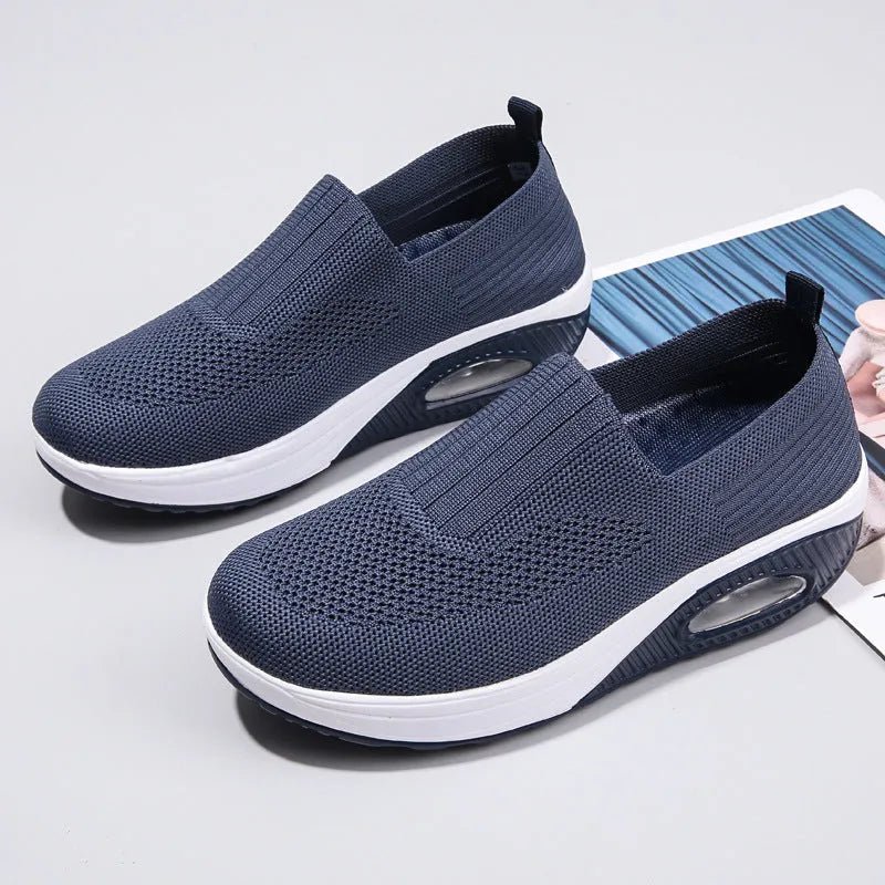 Women's mesh running shoes with air cushion midsole in beige colour on a white background.