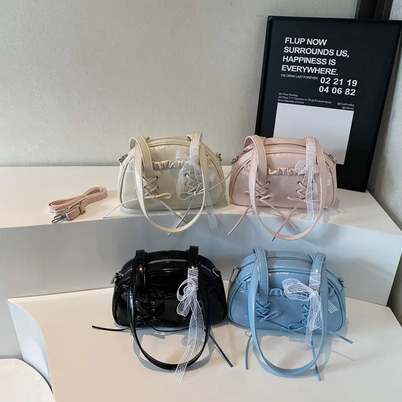 Milky white women's PU shoulder bag with a black bandage bow and sewing thread detail.
