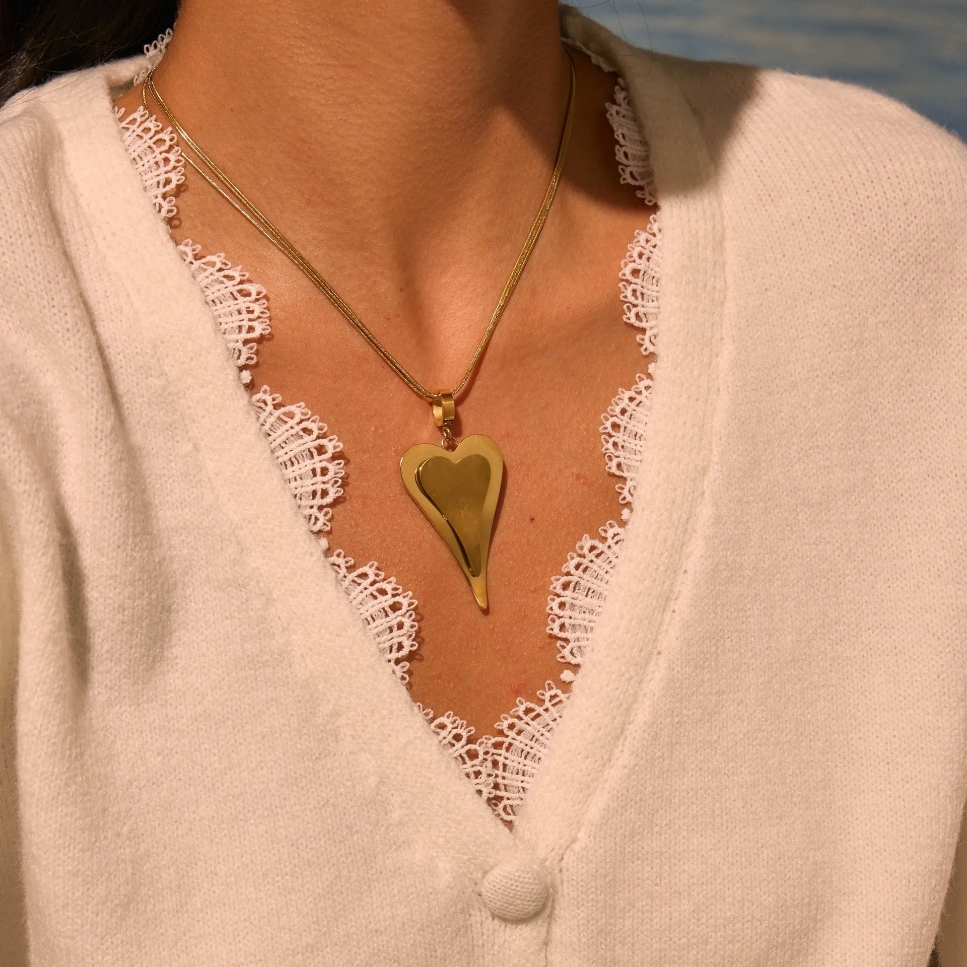 Stainless steel geometric snake bones chain necklace with double heart pendant in gold finish