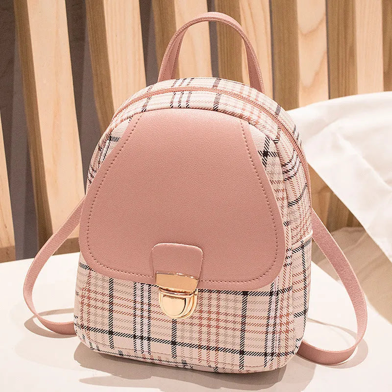 A black one shoulder diagonal phone bag made from PU fabric, shown being worn.