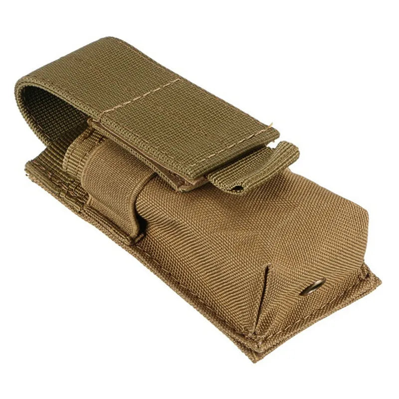Black tactical Molle waist bag with elastic cord closure, shown next to a pistol cartridge for scale.