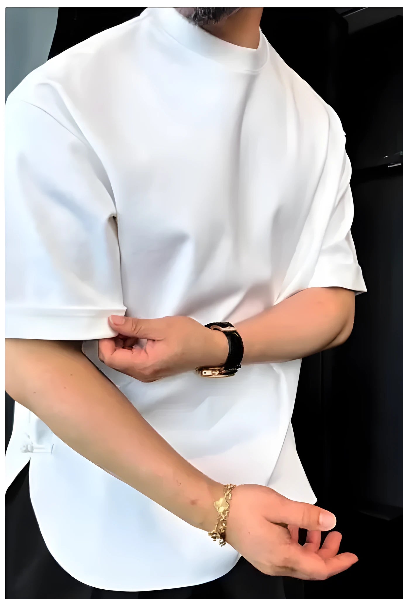 A white men's T-shirt with buttoned front and round hem laid flat.