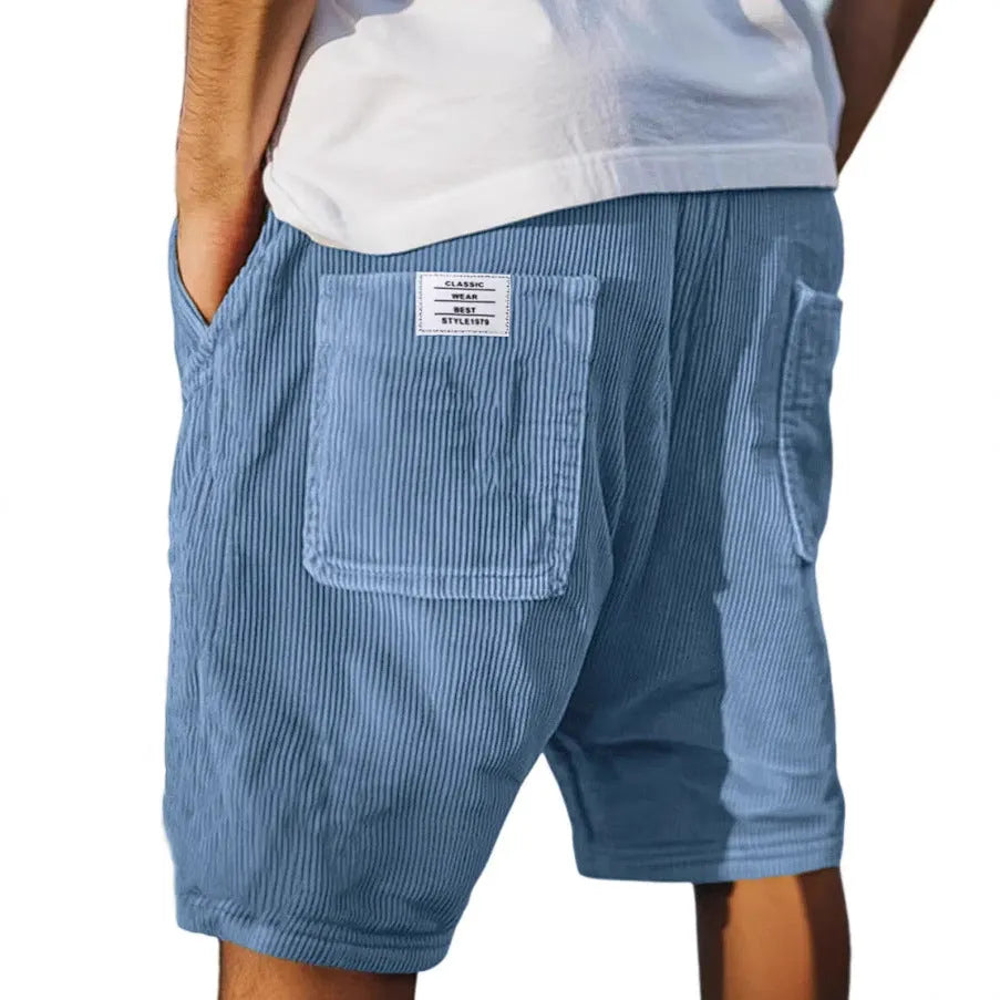 Men's grey corduroy shorts with multiple pockets and embroidery detail on leg, laid flat.