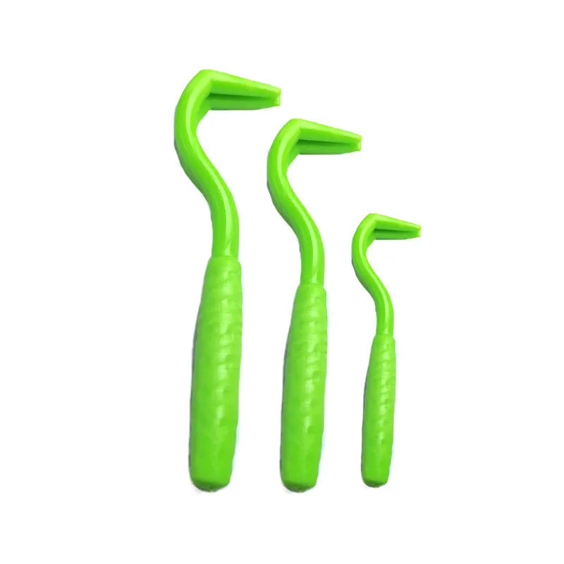 Set of three coloured tick hook removers for dogs on a white background.