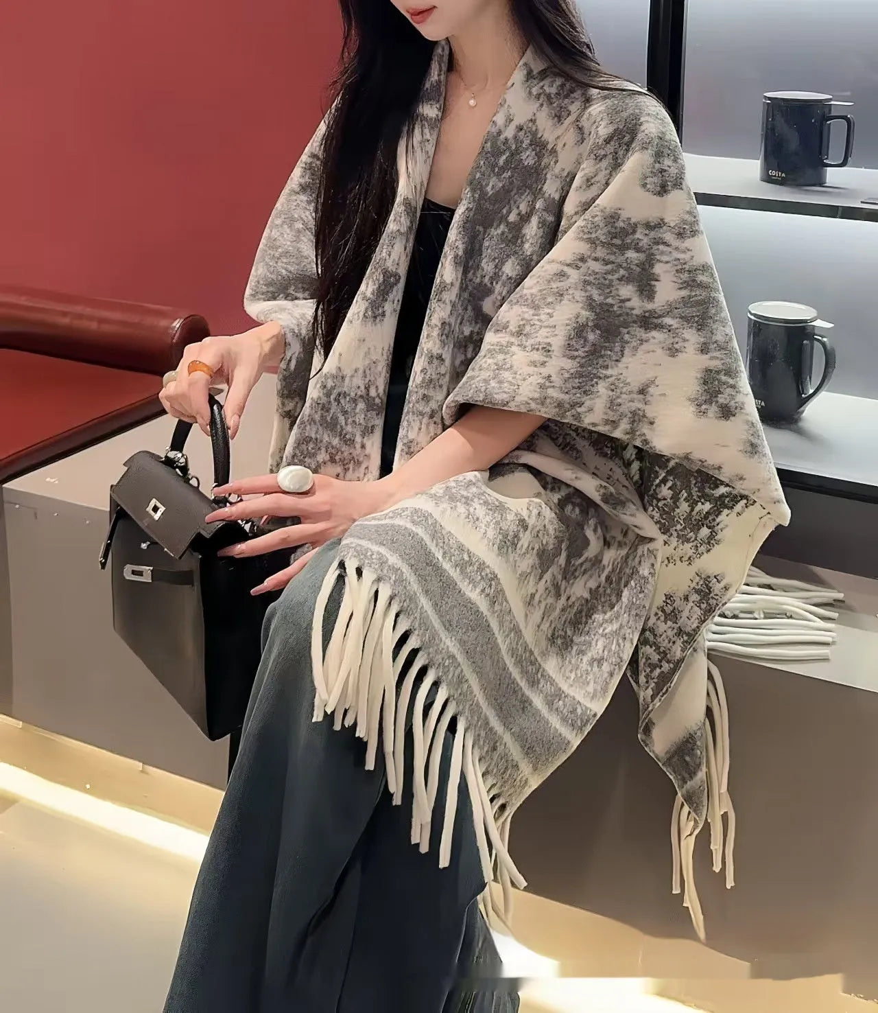 Women's polyester tassel scarf cape draped over shoulders showing fringe detailing