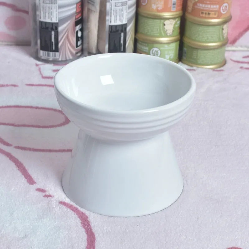 Black ceramic pet bowl with a raised foot and high neck guard for dogs and cats.