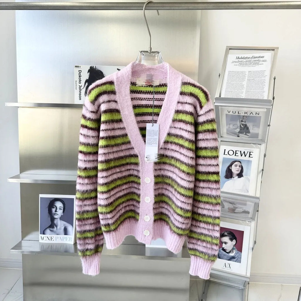 Pink wool lazy coat style cardigan sweater with contrast colour details on a hanger.