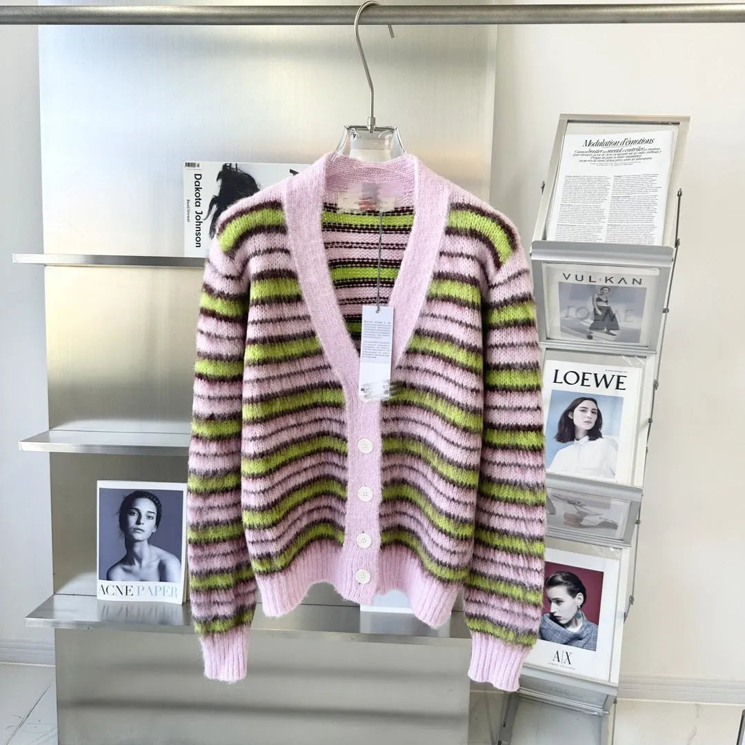 Pink wool lazy coat style cardigan sweater with contrast colour details on a hanger.