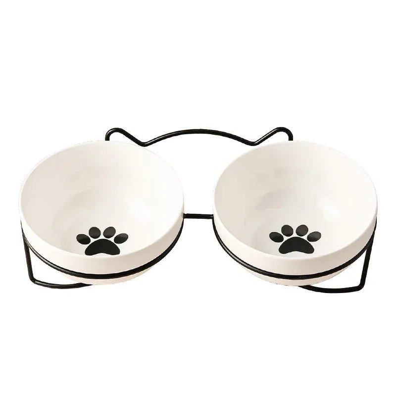 White ceramic cat bowl with cat paw print pattern in a black iron cat-ear frame