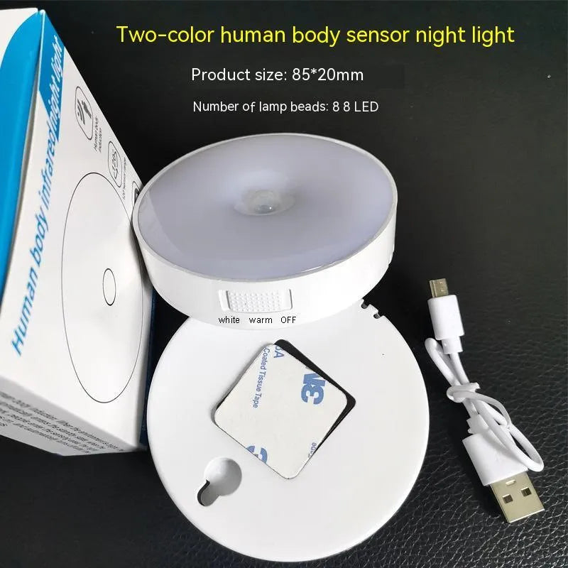 Compact beige motion sensing LED night light with USB charging port and adhesive backing