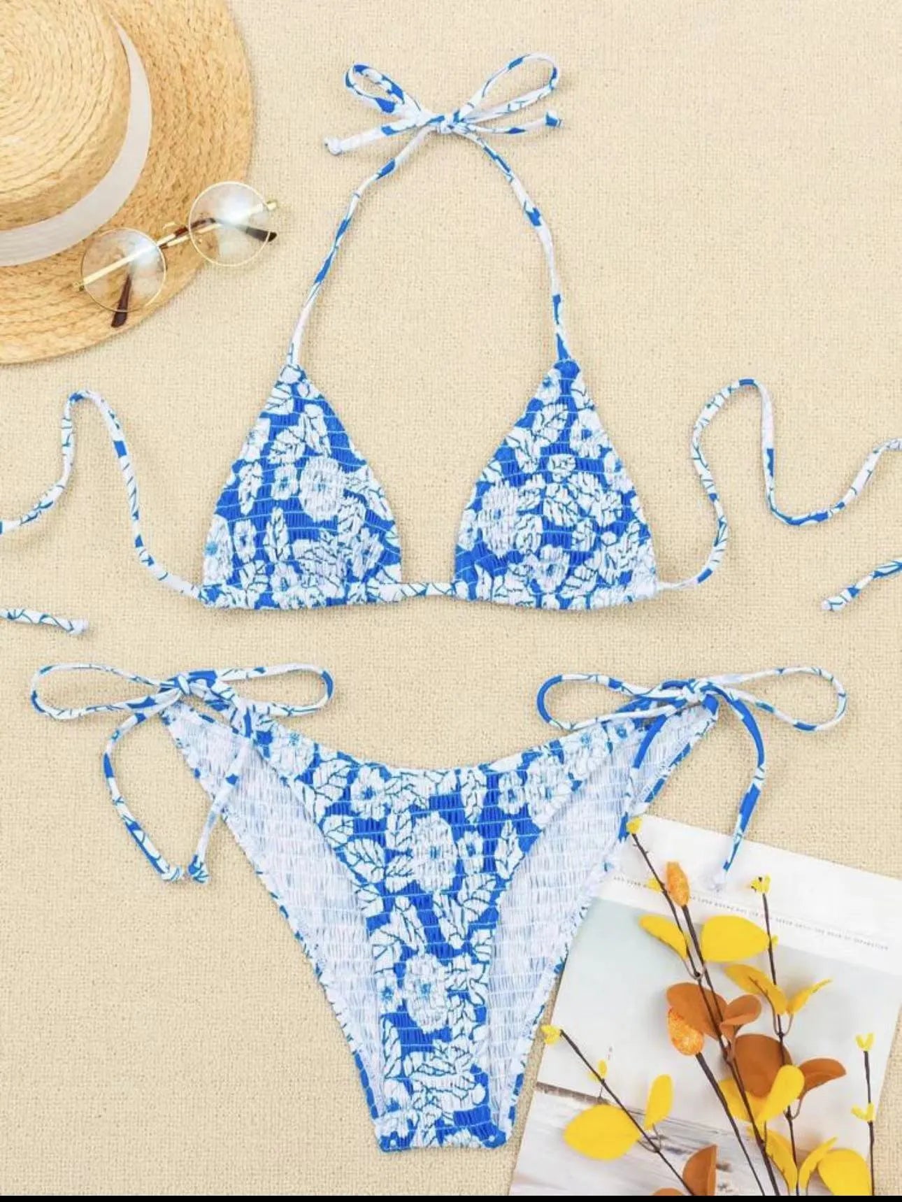 Women's pink floral halter neck swimsuit top and briefs set on a neutral background