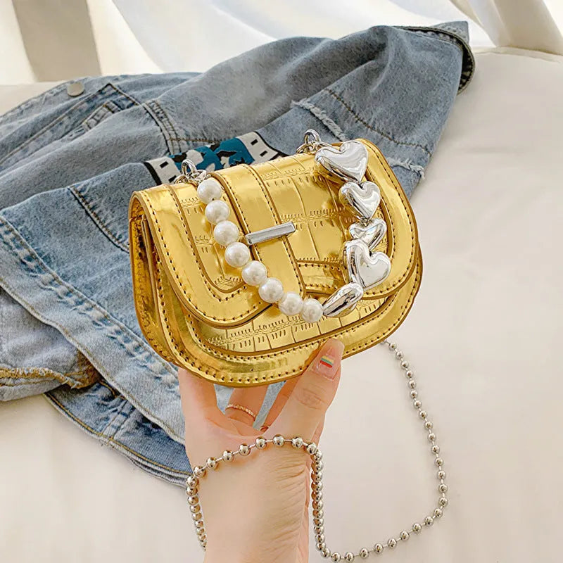 Laser pearl effect mini saddle tote handbag in horizontal square shape with crossbody strap