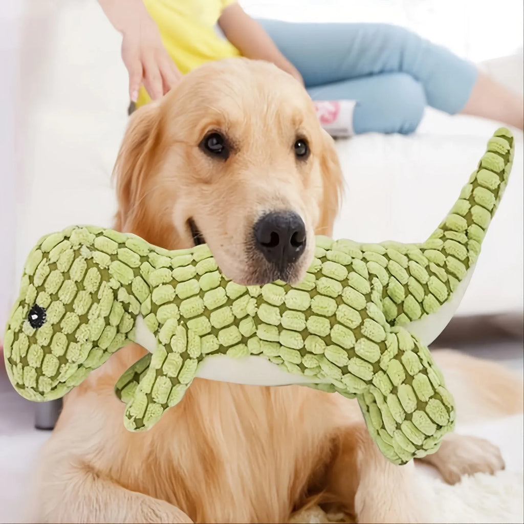 Grey, green, and orange coloured dog chew toy with sound, shown with size scale.