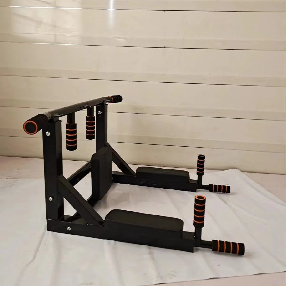 Black wall-mounted fitness frame with sandbag rack and parallel bars for pull-ups