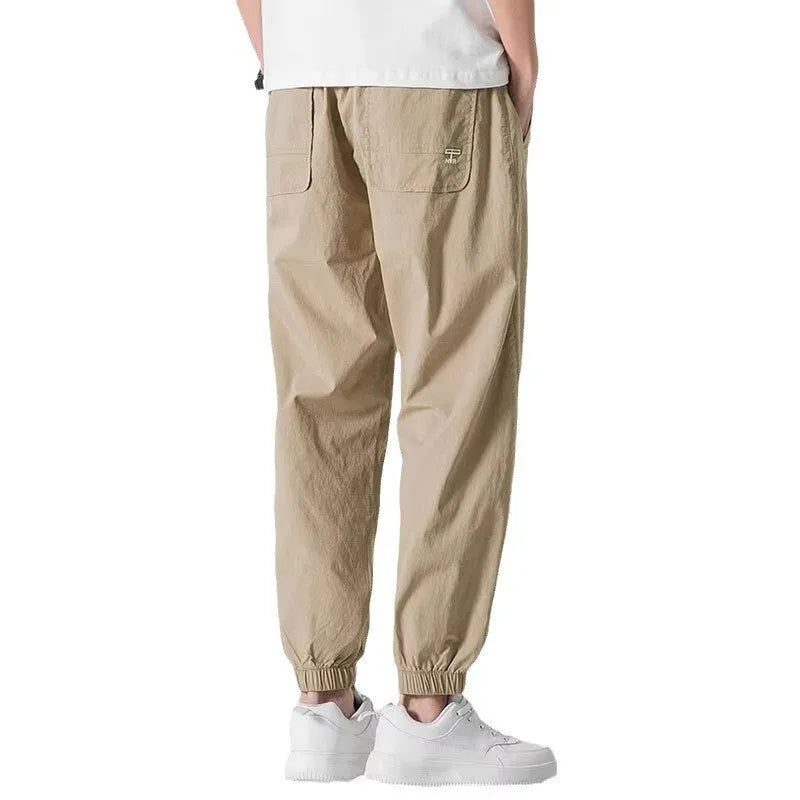 Men's fashion loose cuffed cargo pants in black, made from polyester, available in sizes S to 3XL.