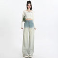Gradient blue women's straight-leg denim trousers showing colour variation from light to dark blue tones