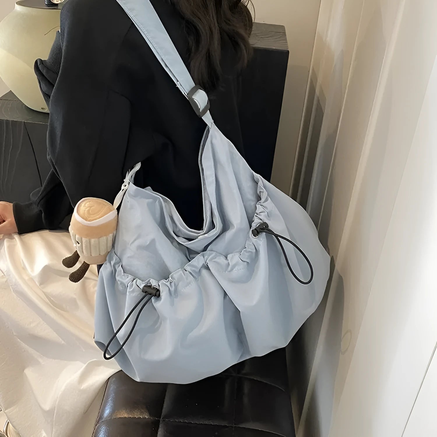 Ultra-light pleated foldable crossbody bag in soft polyester fabric, shown in green with split pockets.
