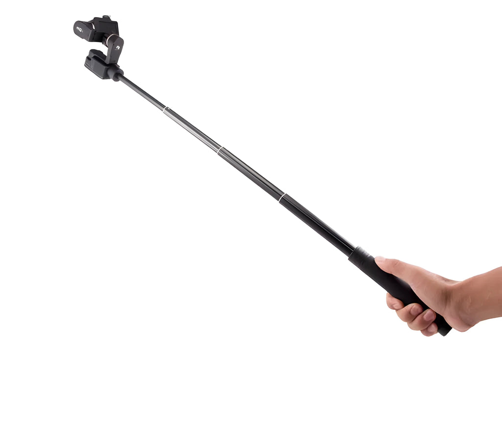 Black aluminium retractable selfie stick extended to full length with phone attached, showing included tripod stand and wireless remote.