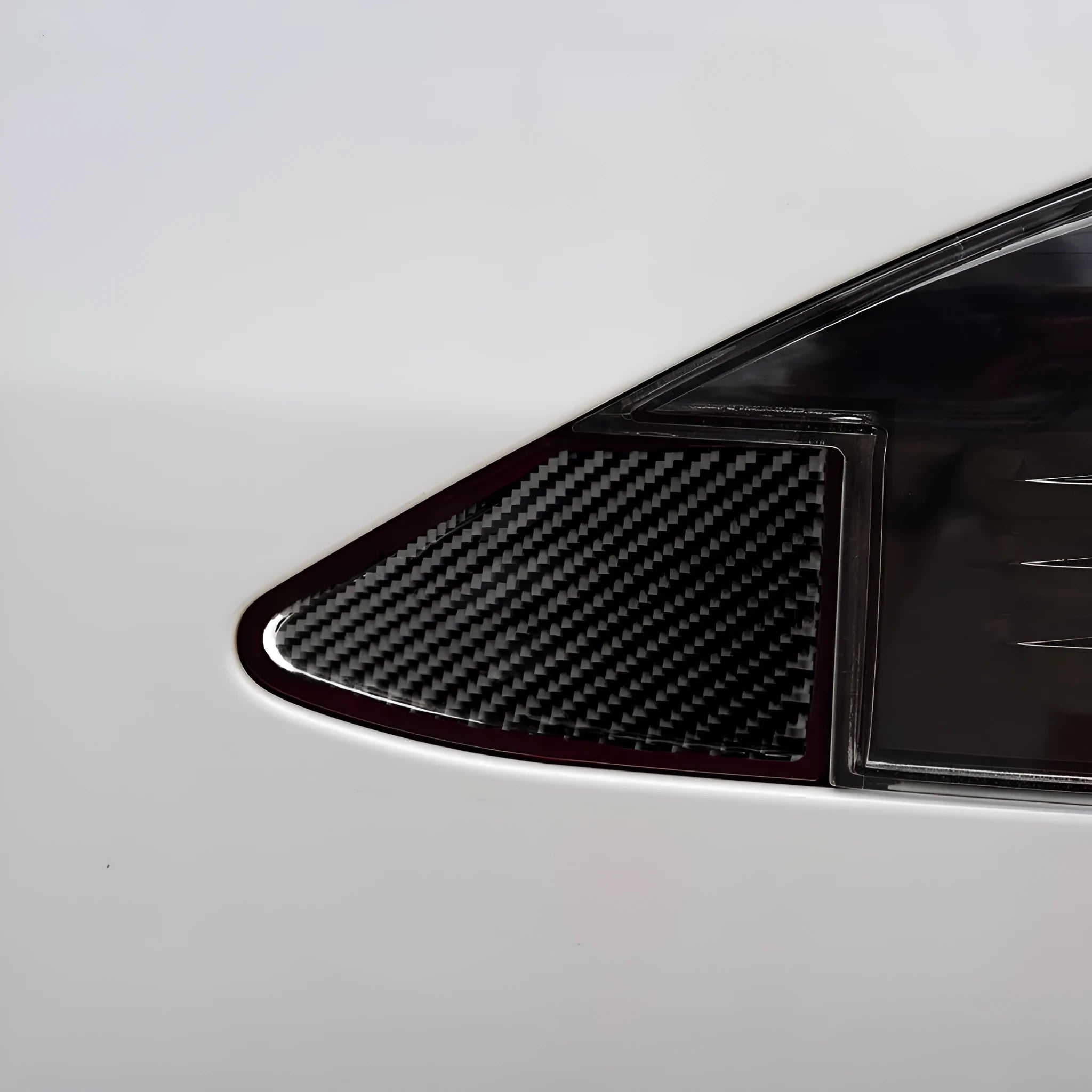 Carbon fibre decorative sticker panel for covering USB and charging ports on electronic devices.