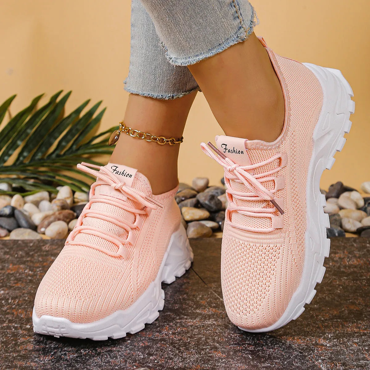 Women's low-top mesh sports sneakers in beige with front lace-up and a subtle platform sole.