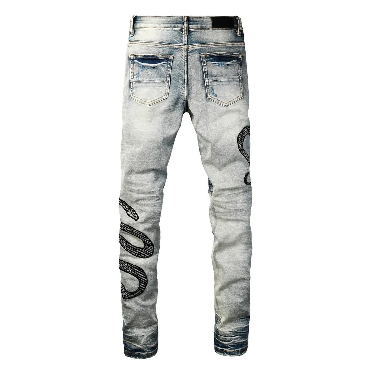 Men's blue distressed skinny jeans with a retro wash, showing a tight leg fit and button fly detail.