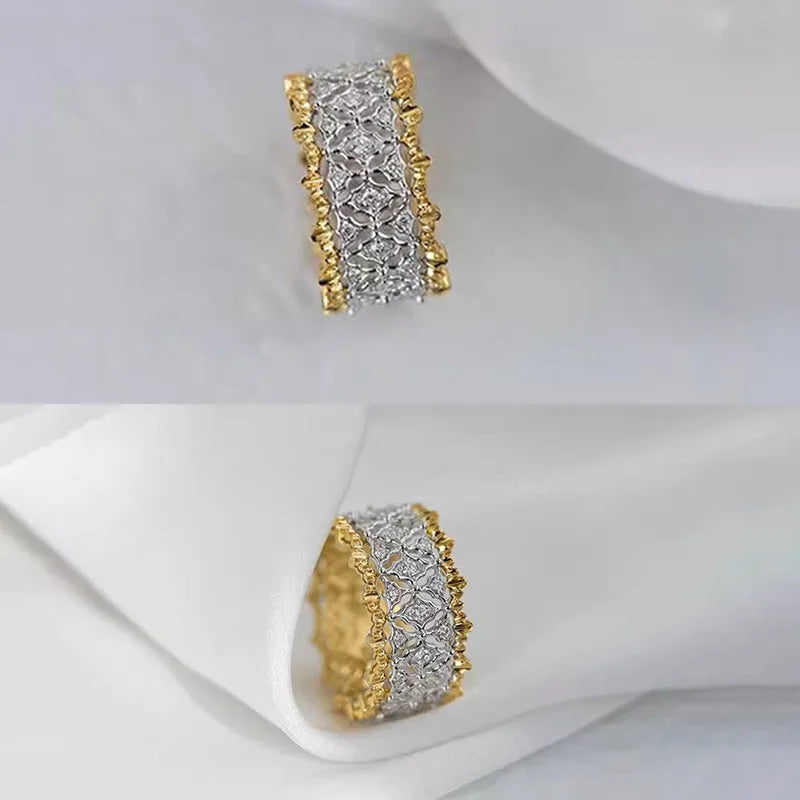 Gold two-tone copper ring with round geometric zircon centrepiece on a plain background.