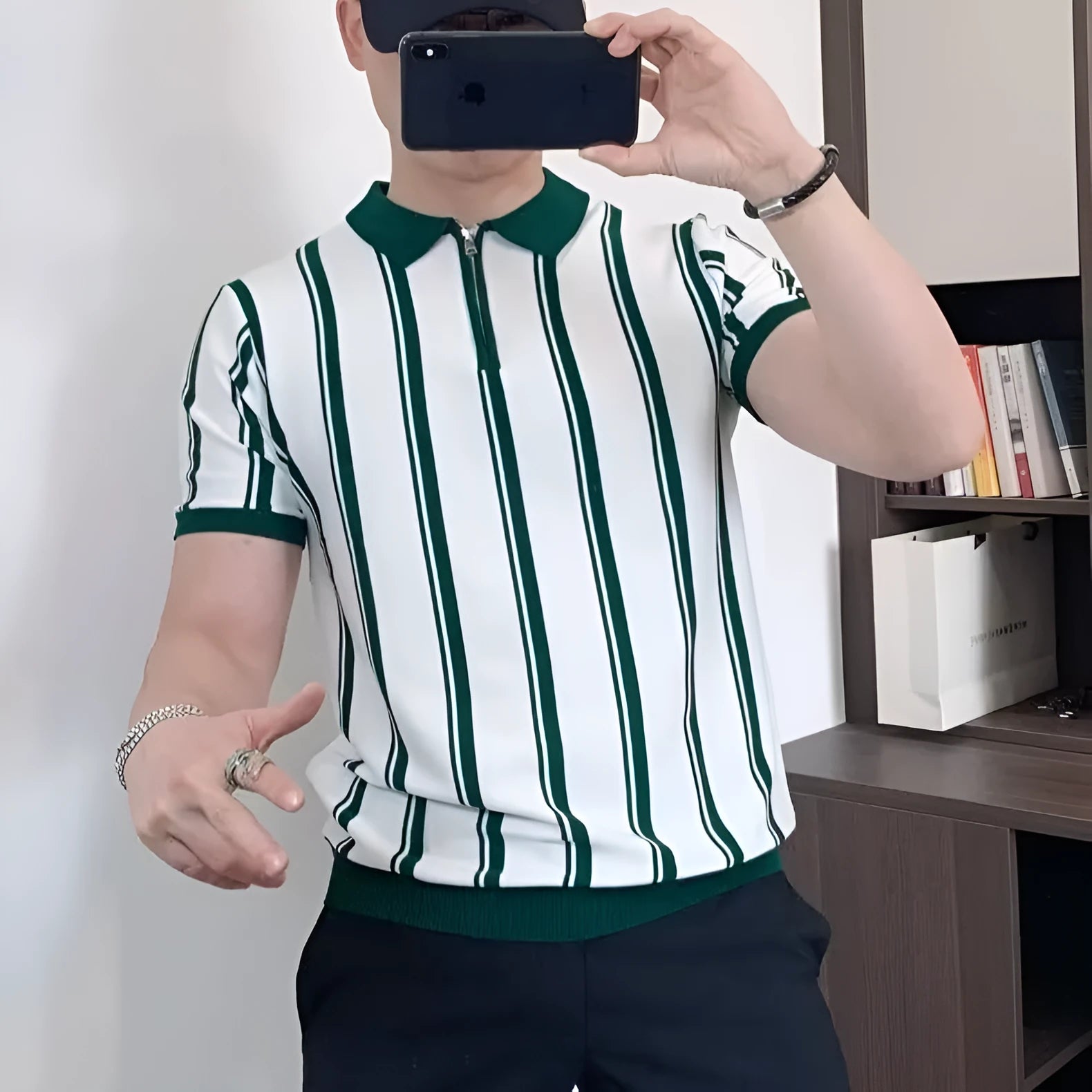Man wearing a black and white vintage stripe T-shirt with a silver front zipper and cartoon graphic.
