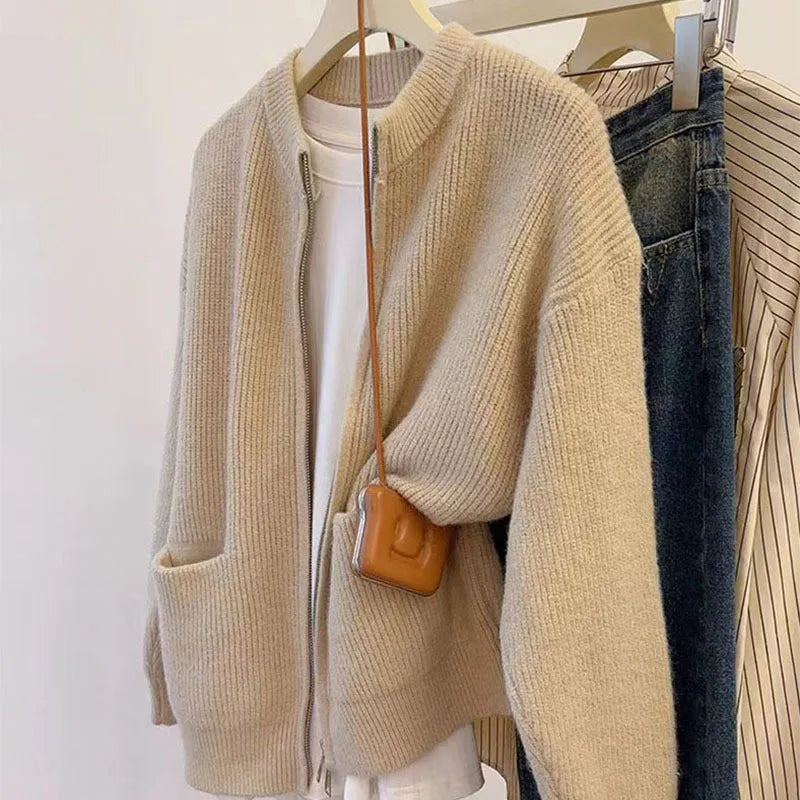 Beige viscose knit cardigan coat with long sleeves on a hanger.