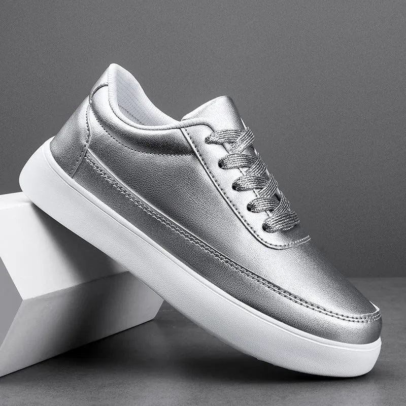 Women's white leather lace-up casual flat trainers on a plain background.
