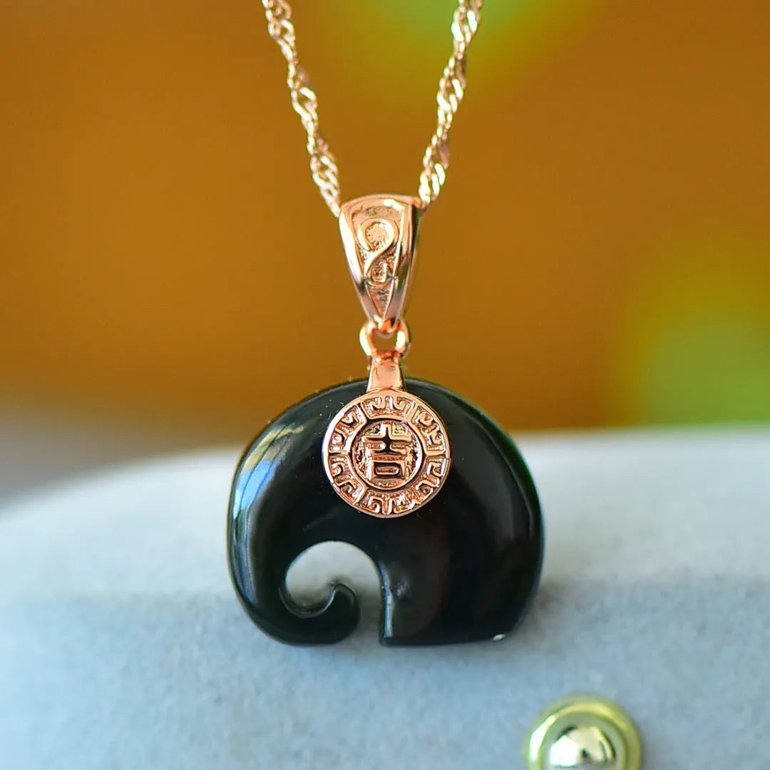 Flat gray and ink blue Hetian Jade pendant with copper inlaid decoration on a necklace.