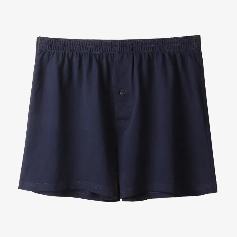 Men's solid-colour pure cotton boxer shorts with a high-waist and loose fit on a plain background.