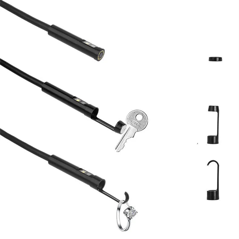 Wireless endoscope with dual-lens camera, magnet, and hook accessories on a table
