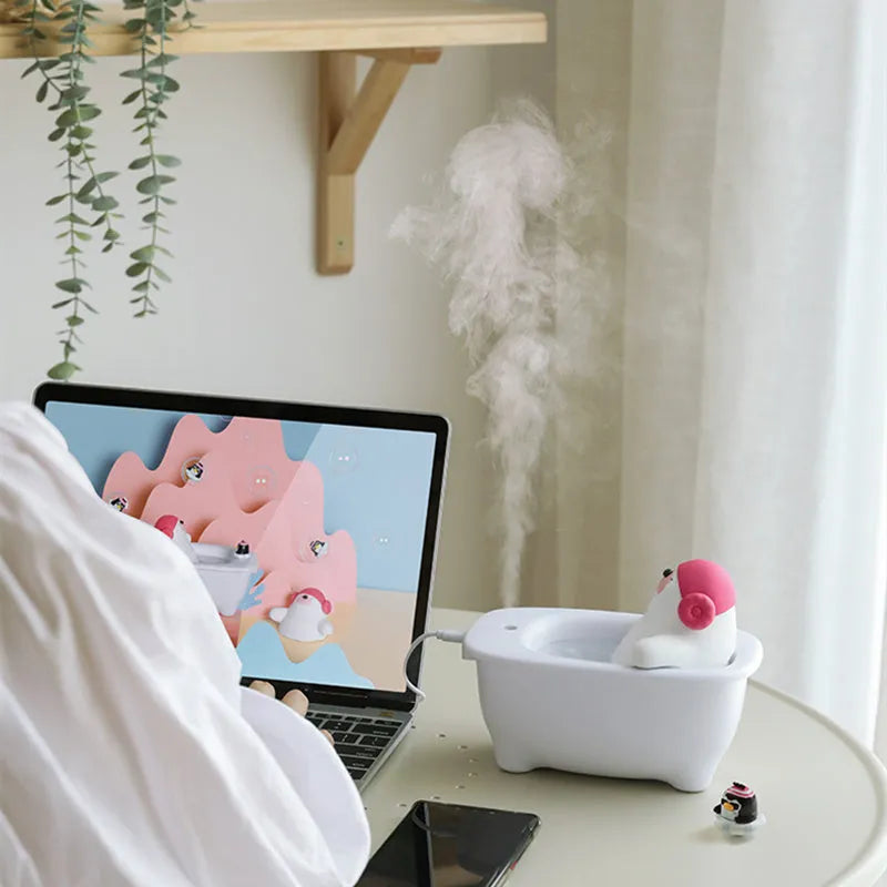 White Creative Air Humidifier with USB cable on a desk, showing its compact size and large water tank.
