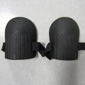 A pair of thick EVA foam kneepads in army green colour on a garden soil background.