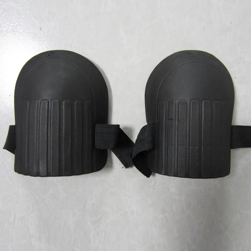 A pair of thick EVA foam kneepads in army green colour on a garden soil background.